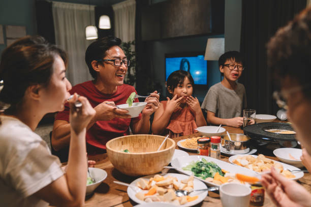 A Cantonese family sharing a meal with WAH XO chilli oil jars on the table.